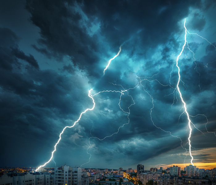 lighting striking a city with disaster recovery on it