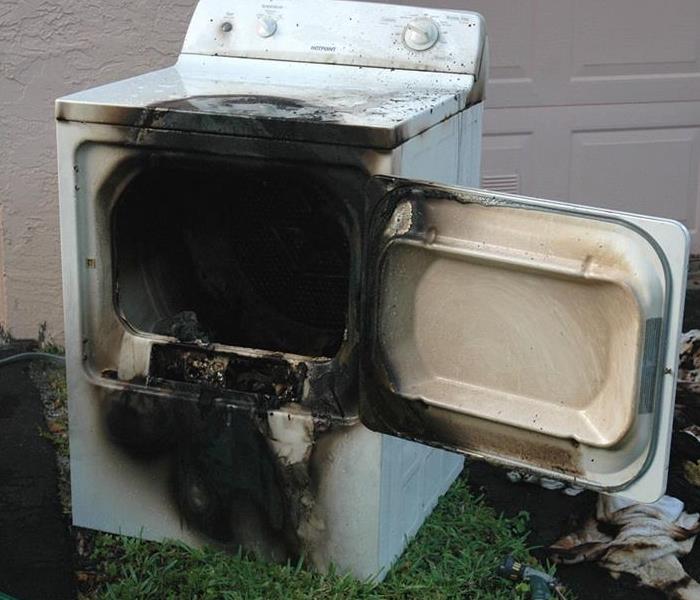 a dryer burned by fire and has lots of smoke damage 